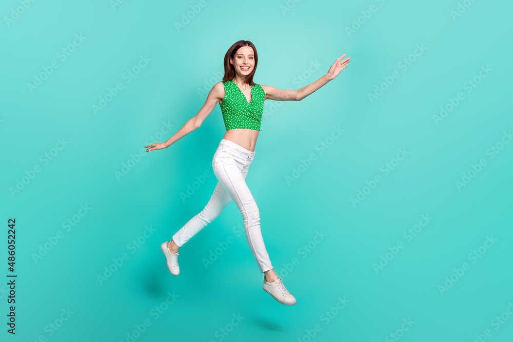 Full length profile side photo of young lady active go hurry motion jump isolated over turquoise color background