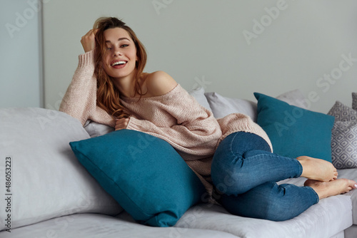 Young caucasian girl resting on sofa at home photo