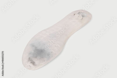 Old and shabby orthopedic insoles isolated on white background. Dirty leather insoles. Worn out things with holes. Inner soles of shoes. Top view banner close up.