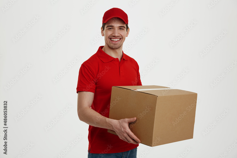 Young caucasian male courier with cardboard box Young caucasian male courier with cardboard box