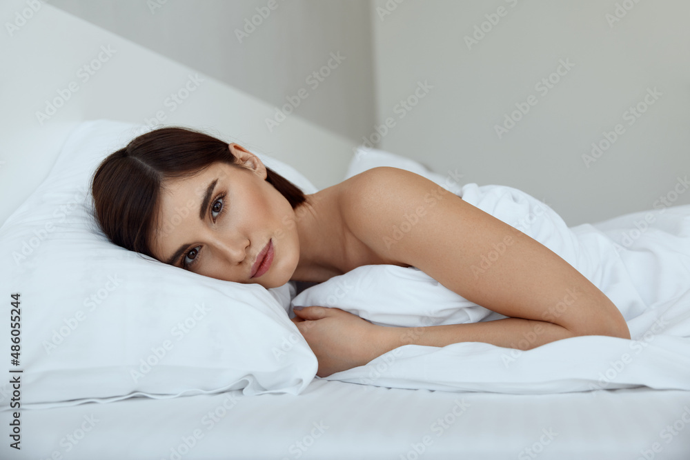 Caucasian girl resting on bed at home at morning Caucasian girl resting on bed at home at morning