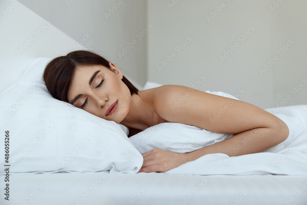 Girl sleeping under blanket on bed at home Girl sleeping under blanket on bed at home