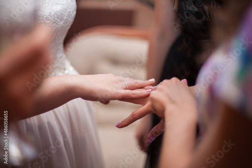 the bride shows her wedding ring to her girlfriends