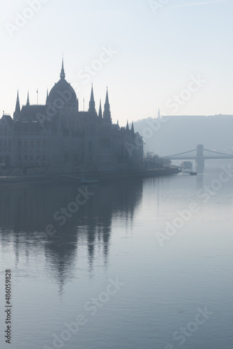 Parliament building and Szechenyi chain bridge in morning haze in Budapest, Hungary