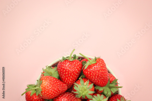 Half top view of strawberries in a cup with copy space.