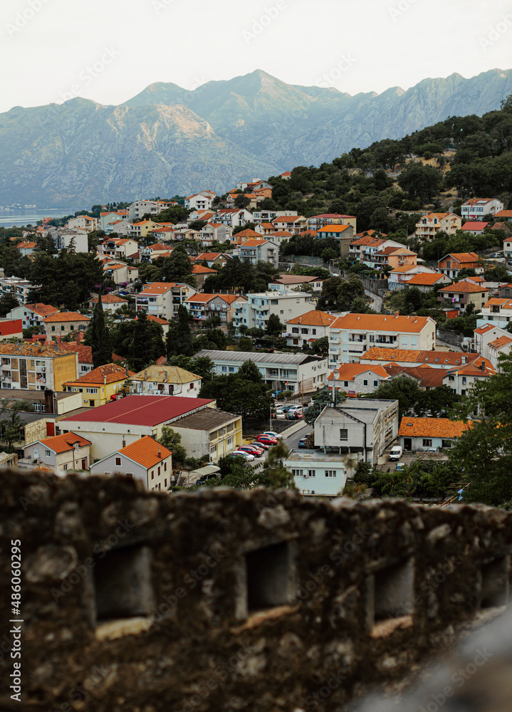Fototapeta premium Roofs of the town. Red roof background. Historical part of the european city. Panorama of the city. Explore Montenegro