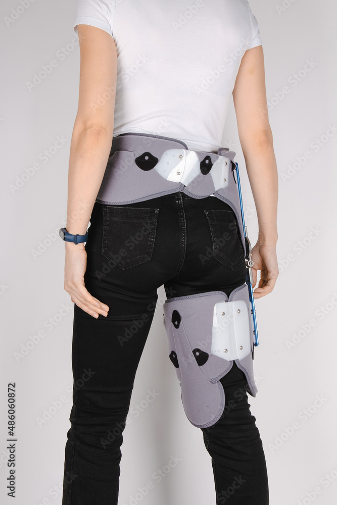 Orthopedic adjustable support brace for knee and hip fixation. Hip abduction  orthosis. Knee brace or leg brace after hip fracture or a replacement  revision surgery. Rehabilitation for knee injury. Stock Photo