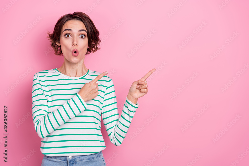 Portrait of attractive amazed girl demonstrating copy blank space advert new info isolated over pink pastel color background Portrait of attractive amazed girl demonstrating copy blank space advert new info isolated over pink pastel color background