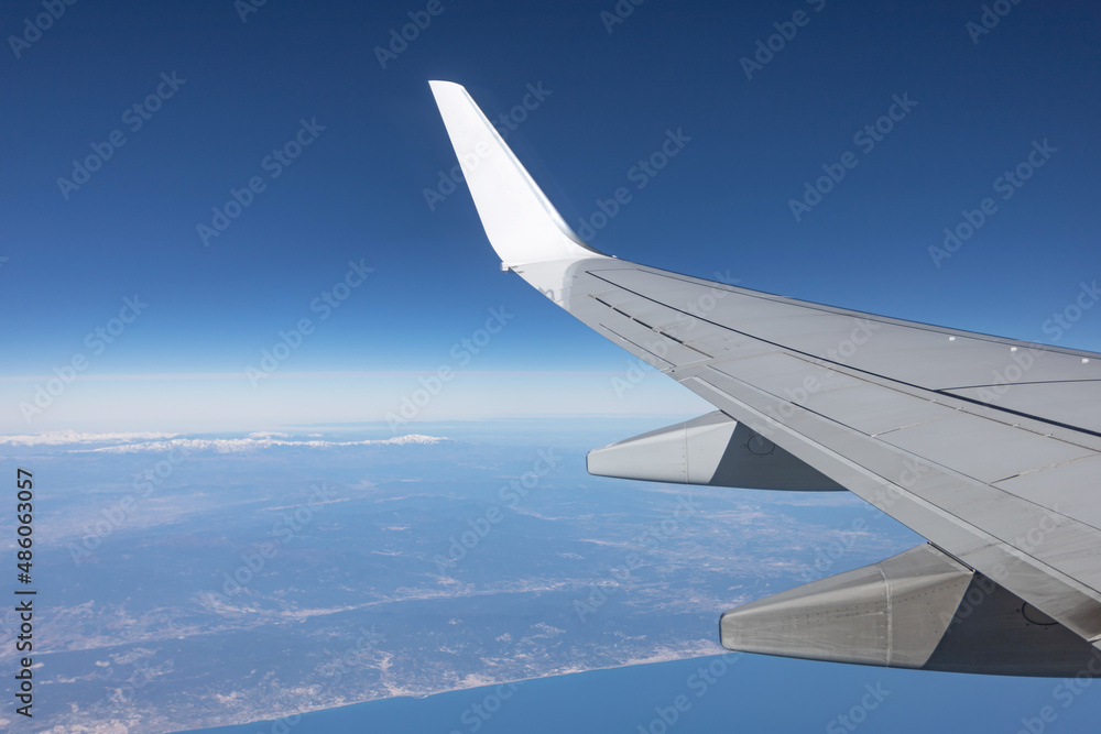 Fototapeta premium view from the plane window. wing and city. air travel