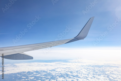 travel concept. wing of the plane. flying high above the clouds.