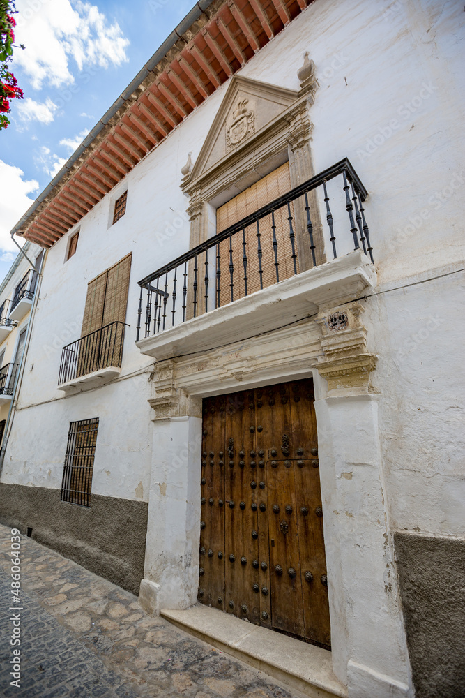 Balcony over the entrance. Alhama de Granada, Andalusia, Spain.
Beautiful and interesting travel destination in the warm Southern region. Public street view.