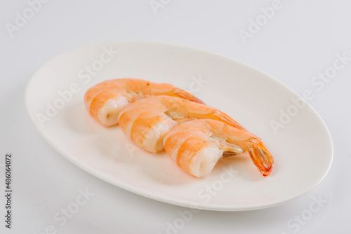 boiled king prawns on a white plate on a white background