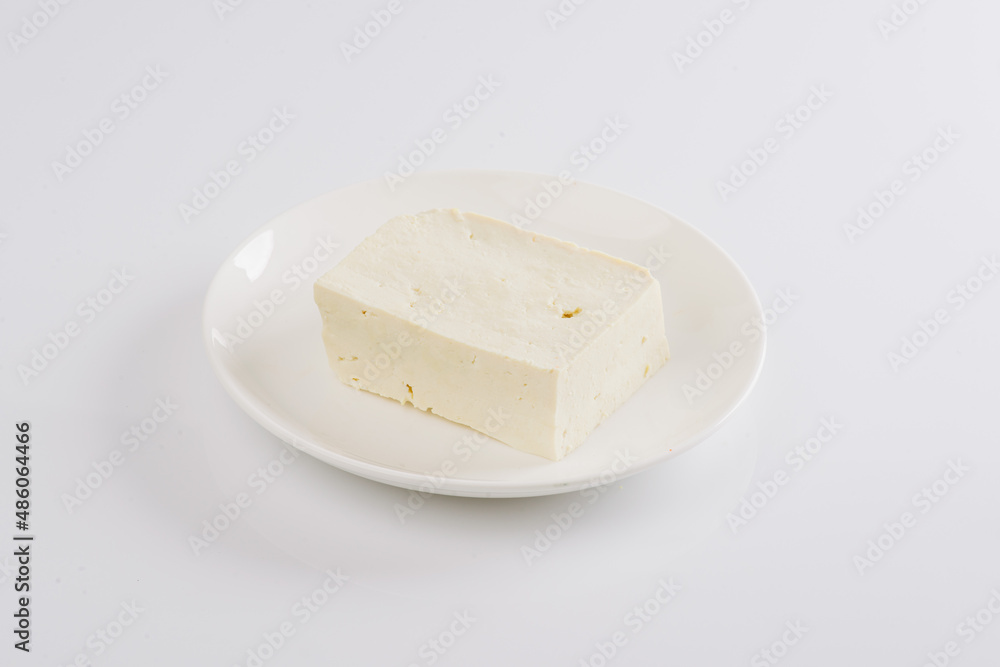 tofu cheese on a white plate on a white background tofu cheese on a white plate on a white background
