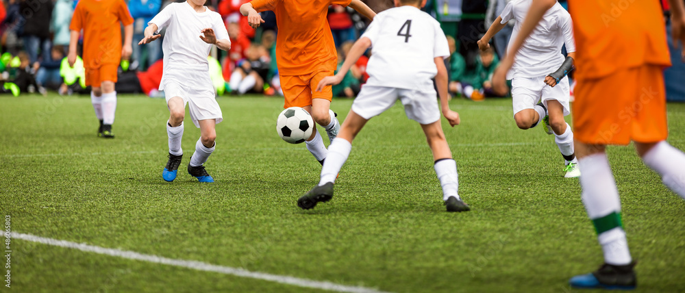 Soccer football duel moment. Two young soccer team on tournament match. Players compete in a game