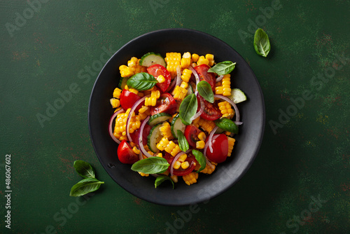 healthy vegetarian tomato sweet corn salad with cucumber and basil photo