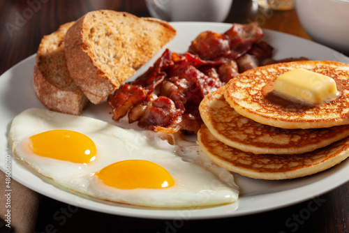 traditional full american breakfast eggs pancakes with bacon and toast