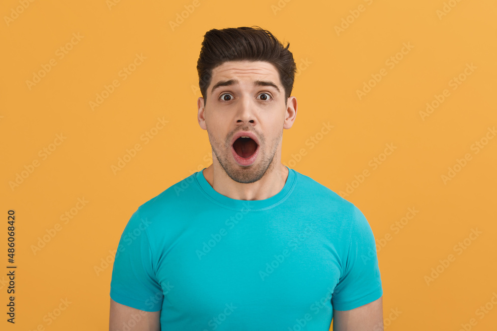 Young caucasian man on orange background in studio Young caucasian man on orange background in studio