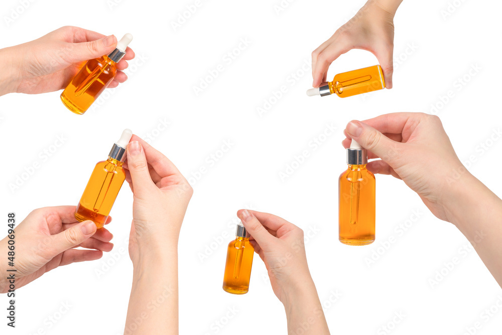 Bottle with oil in woman hand isolated on white. Bottle with oil in woman hand isolated on white.