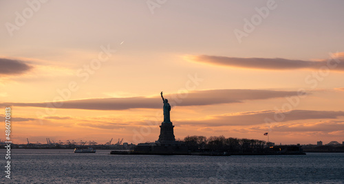 Statue of liberty silhouette at sunset 