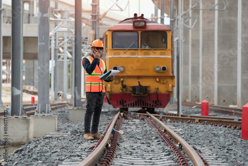 train on the railway. engineer standing on railway inspection on Locomotive background. construction worker on railways. Engineer work on railway.rail,engineer,Infrastructure