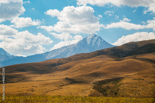 amazing mountain peaks under blue sky and clouds