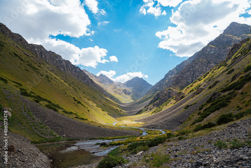 mountain gorge under sky with clouds
