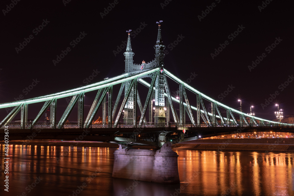 Liberty Bridge across Danube river illuminated at night in Budapest, Hungary