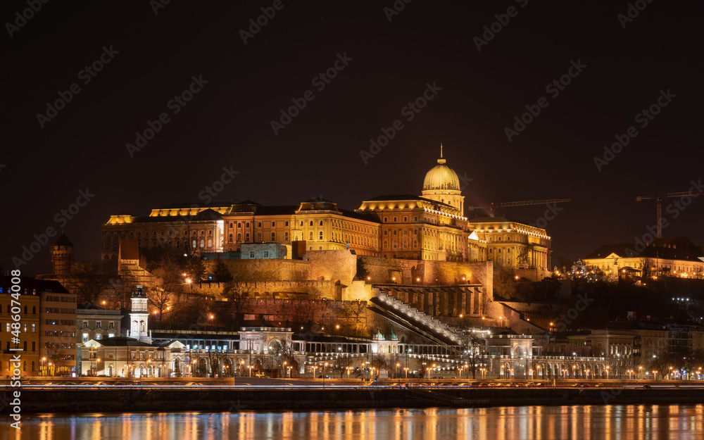 Buda castle from across Danube river illuminated at night, Budapest, Hungary