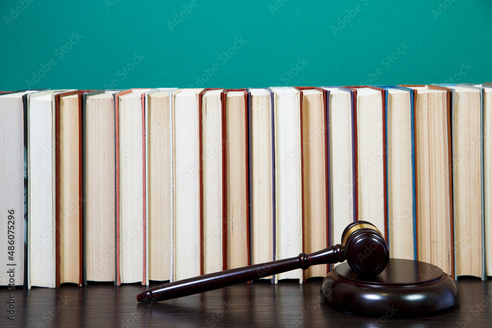 law book with a wooden judges gavel on table law book with a wooden judges gavel on table