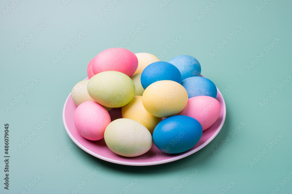Easter colored eggs on a plate. Bright Easter Holiday Easter colored eggs on a plate. Bright Easter Holiday