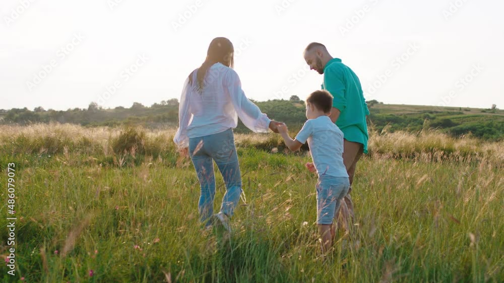 Perfect time with family spending at nature in the middle of nature they chilling walking through the field Perfect time with family spending at nature in the middle of nature they chilling walking through the field