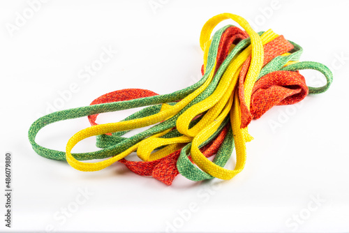 colored laces or accessories used in the manufacture of textiles, standing on a silver background. Ropes standing on white background. textile accessories. colored laces.