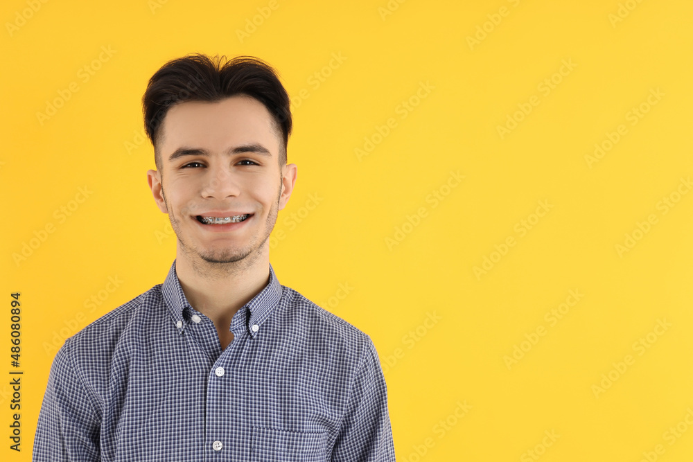 Attractive guy in shirt on yellow background Attractive guy in shirt on yellow background