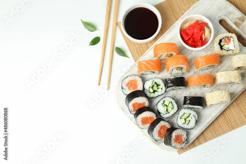 Concept of tasty food with sushi rolls on white background