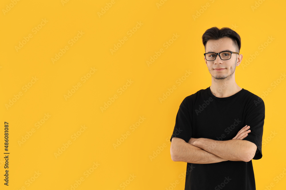 Young man in glasses on yellow background Young man in glasses on yellow background