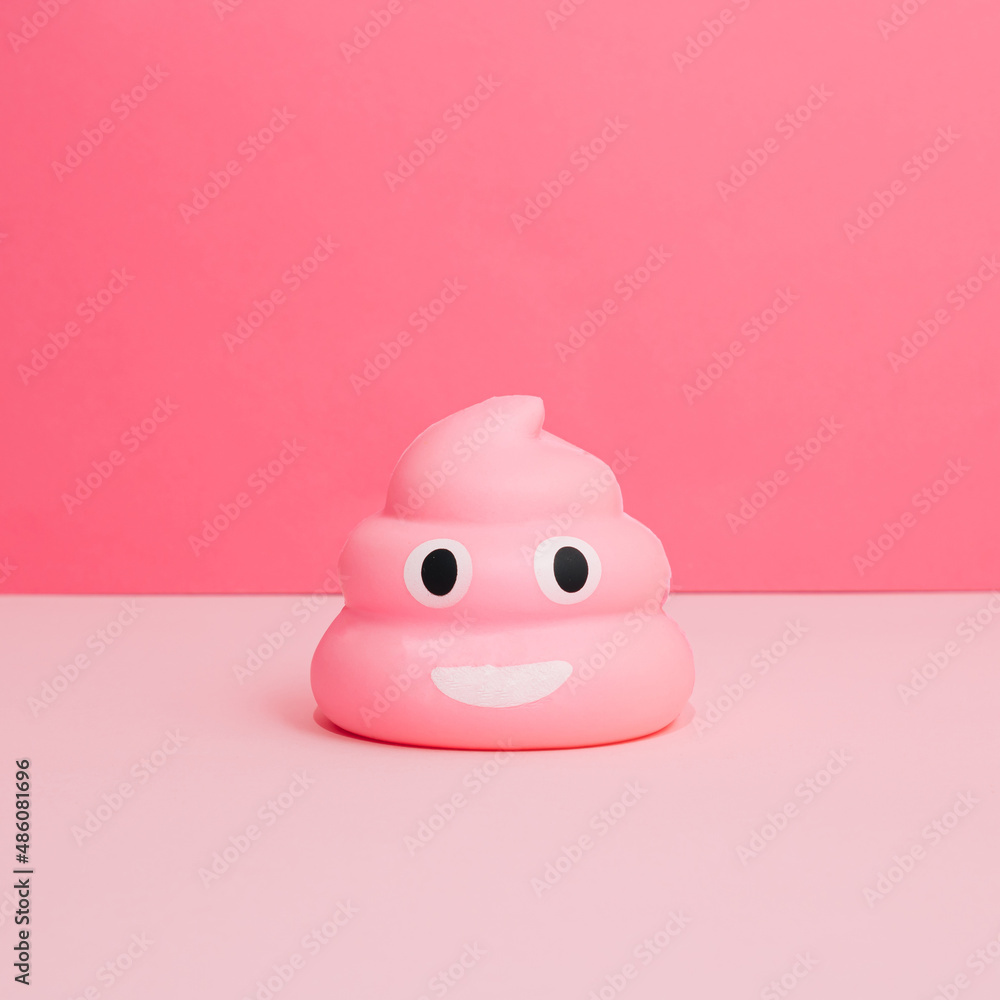 Pink poop emoticon on pastel pink background. Funny concept. Pink poop emoticon on pastel pink background. Funny concept.