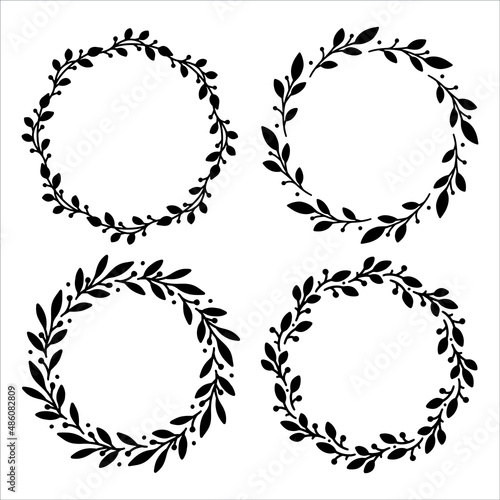 Set of 4 hand drawn spring wreaths isolated on white background, vector. Silhouette frames of leaves. Doodle style.Collection of floral frames.