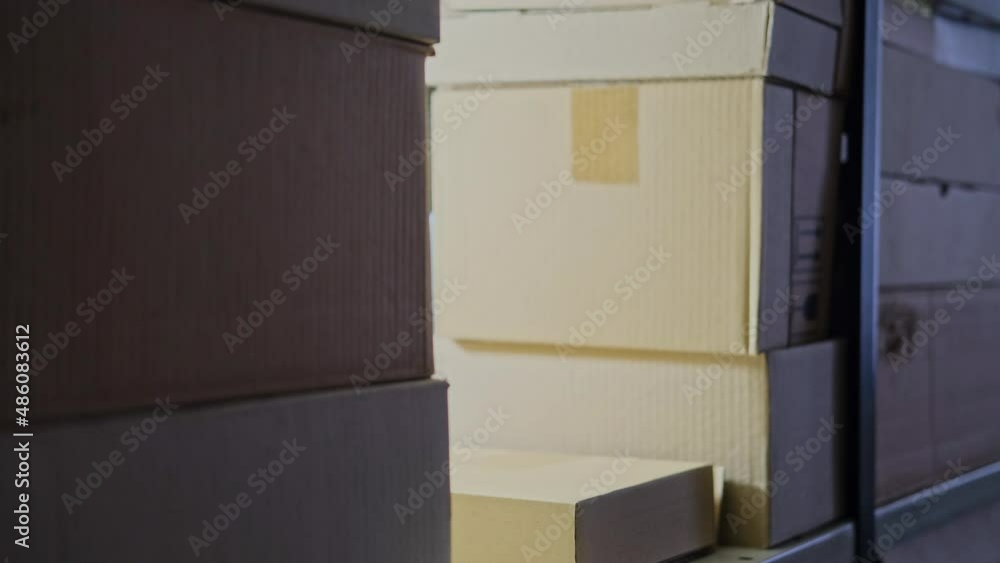 A man in gloves steals box in a warehouse. Problems with theft and security in the office A man in gloves steals box in a warehouse. Problems with theft and security in the office