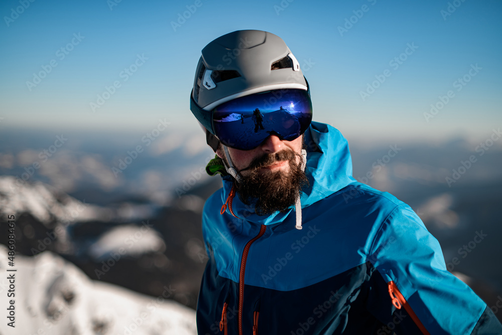 Portrait of man with ski helmet and goggles against a blurred background Portrait of man with ski helmet and goggles against a blurred background