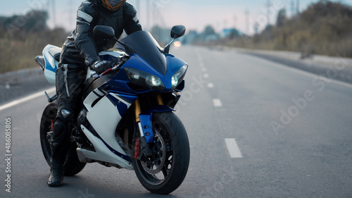 Biker on a sports motorcycle on the road.