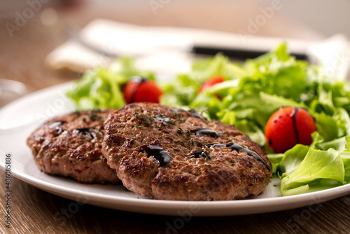 Homemade Hamburgers with Green Salad on a Plate.