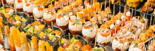 Fototapeta Photo of a lot of delicious fruit desserts and aperitives for a party