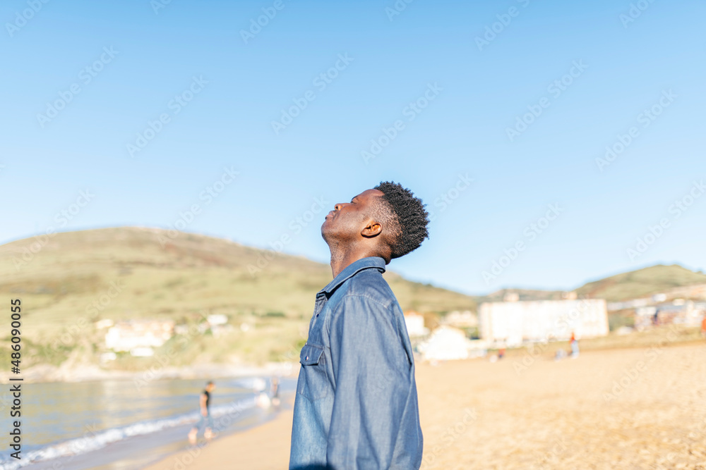 african american man breathing fresh air at the beach on a sunny day african american man breathing fresh air at the beach on a sunny day