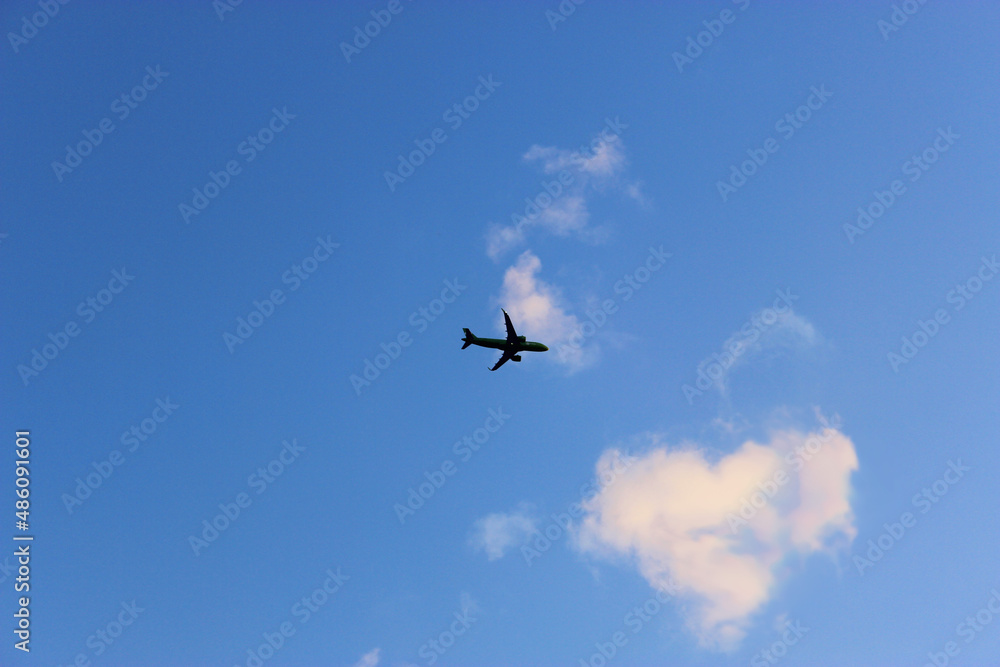 Jet plane in the sky with Condensation trace The only plane in the blue sky Jet plane in the sky with Condensation trace The only plane in the blue sky