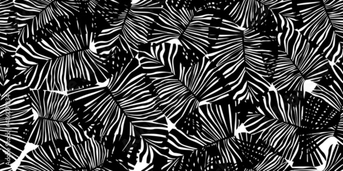 Monochrome tropical palm leaves seamless pattern. Black and white exotic botanical texture.