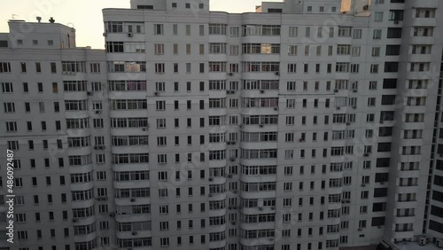 drone flying near high-rise building in winter at sunset. 4k footage aerial