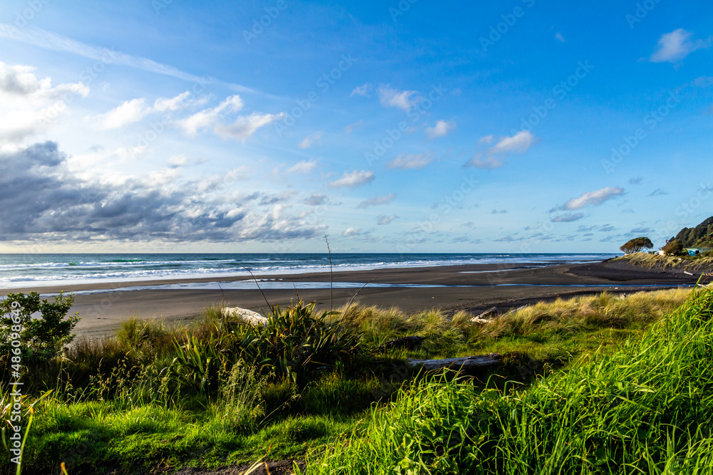 Waves and black sand highlight a visit to the beach. Taranaki, Beach, Taranaki, New Zealand..