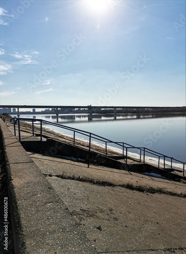Embankment with stairs on the spring river