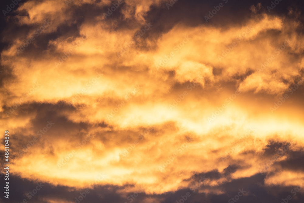  Close up view of beautiful colored dramatic cumulus fluffy clouds on blue sky at sunset background