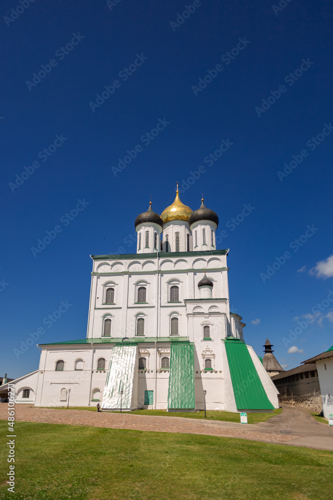 Holy Trinity Cathedral is an Orthodox church in Pskov. Summer sunny day, blue sky. Vertical photo.